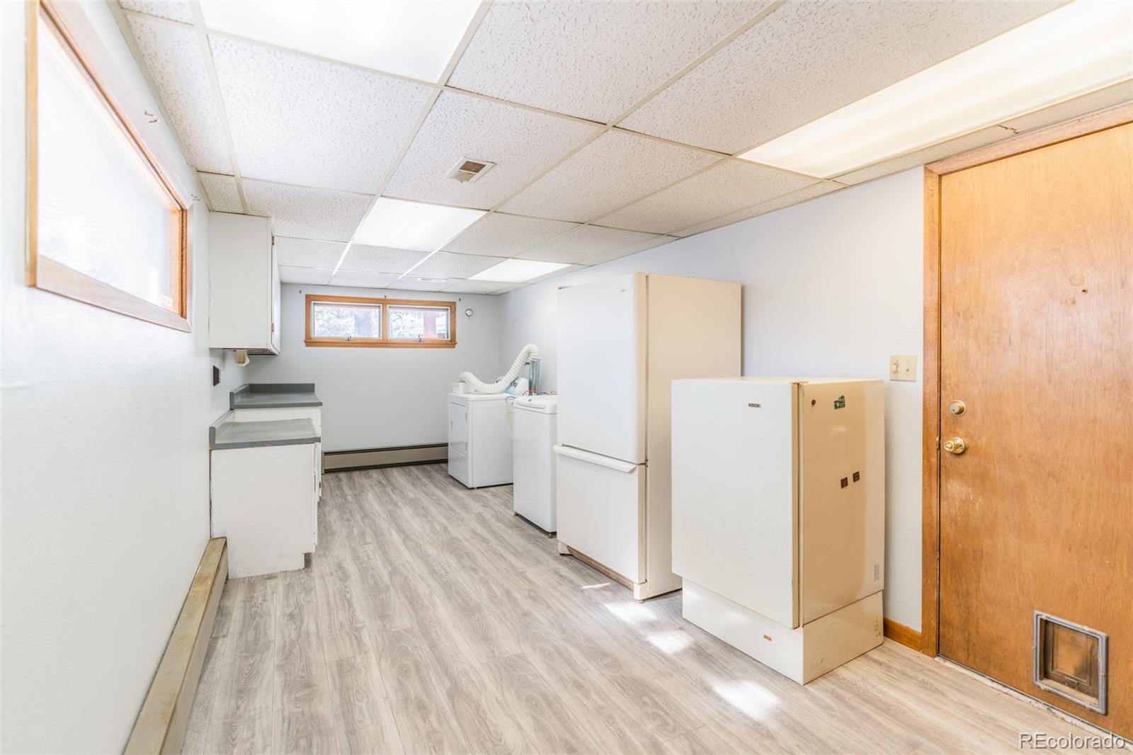 1189 Aspen Drive Evergreen, CO 80439 - Photo 26 of 37 a view of a kitchen with a refrigerator a stove top oven and cabinets