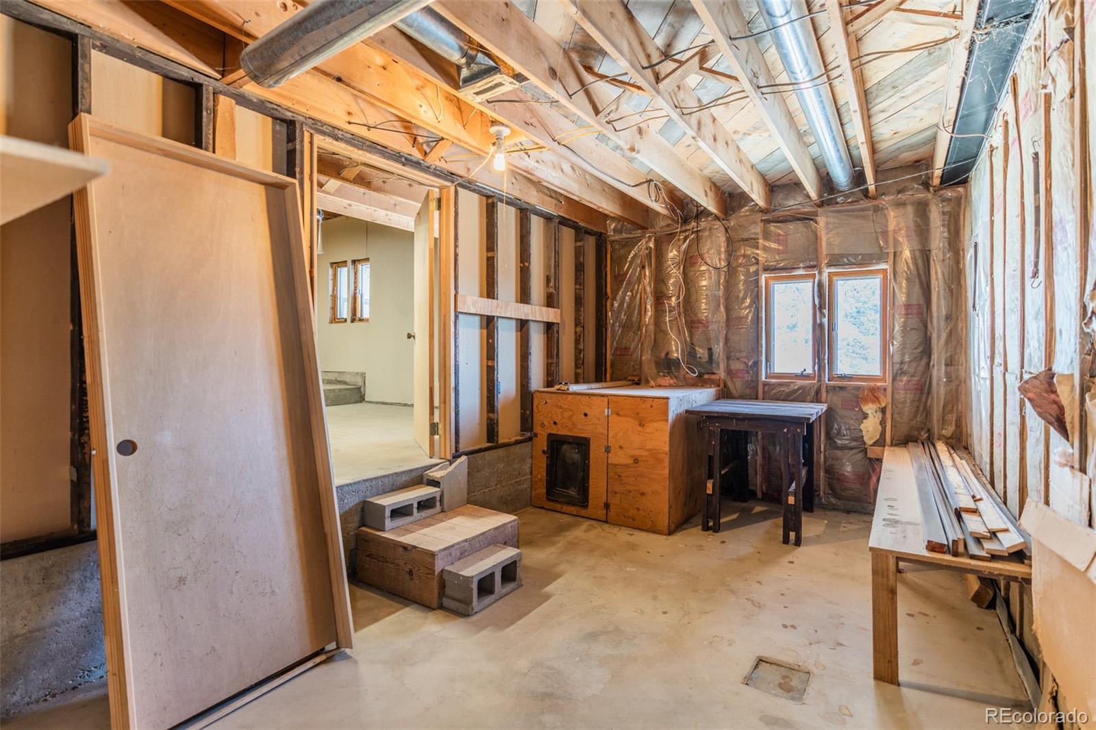 1189 Aspen Drive Evergreen, CO 80439 - Photo 27 of 37 a view of a patio with a couple of cars parked in a yard