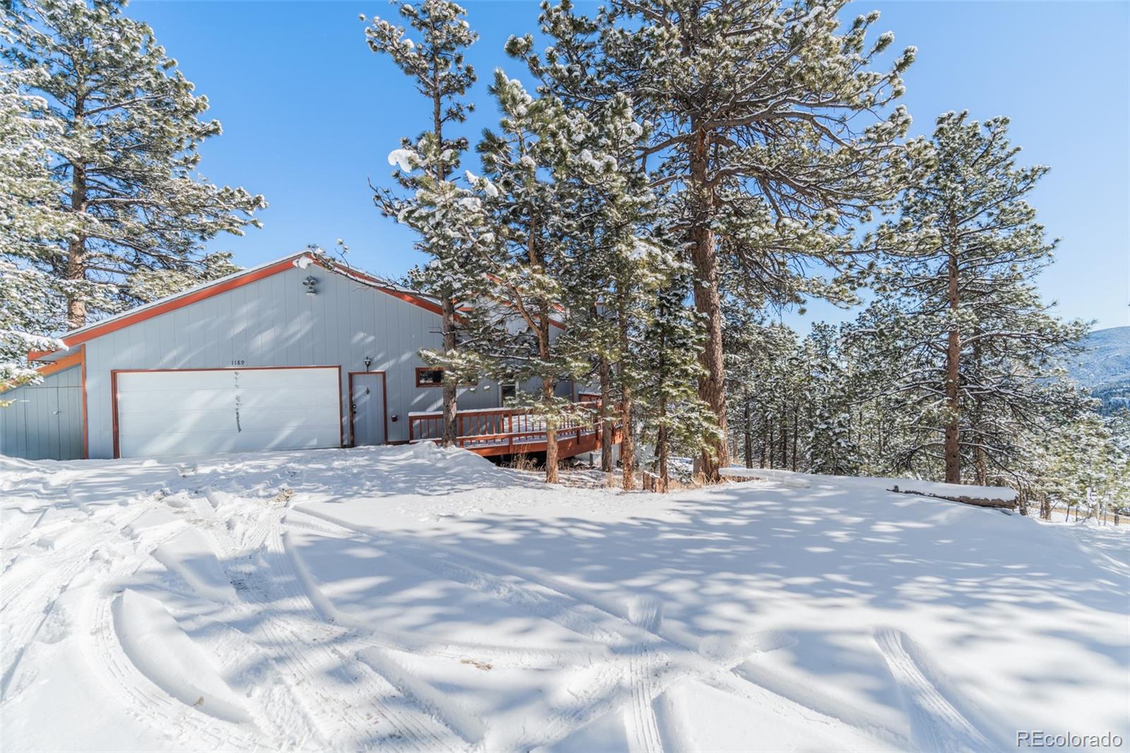 1189 Aspen Drive Evergreen, CO 80439 - Photo 3 of 37 a view of house with trees in the background
