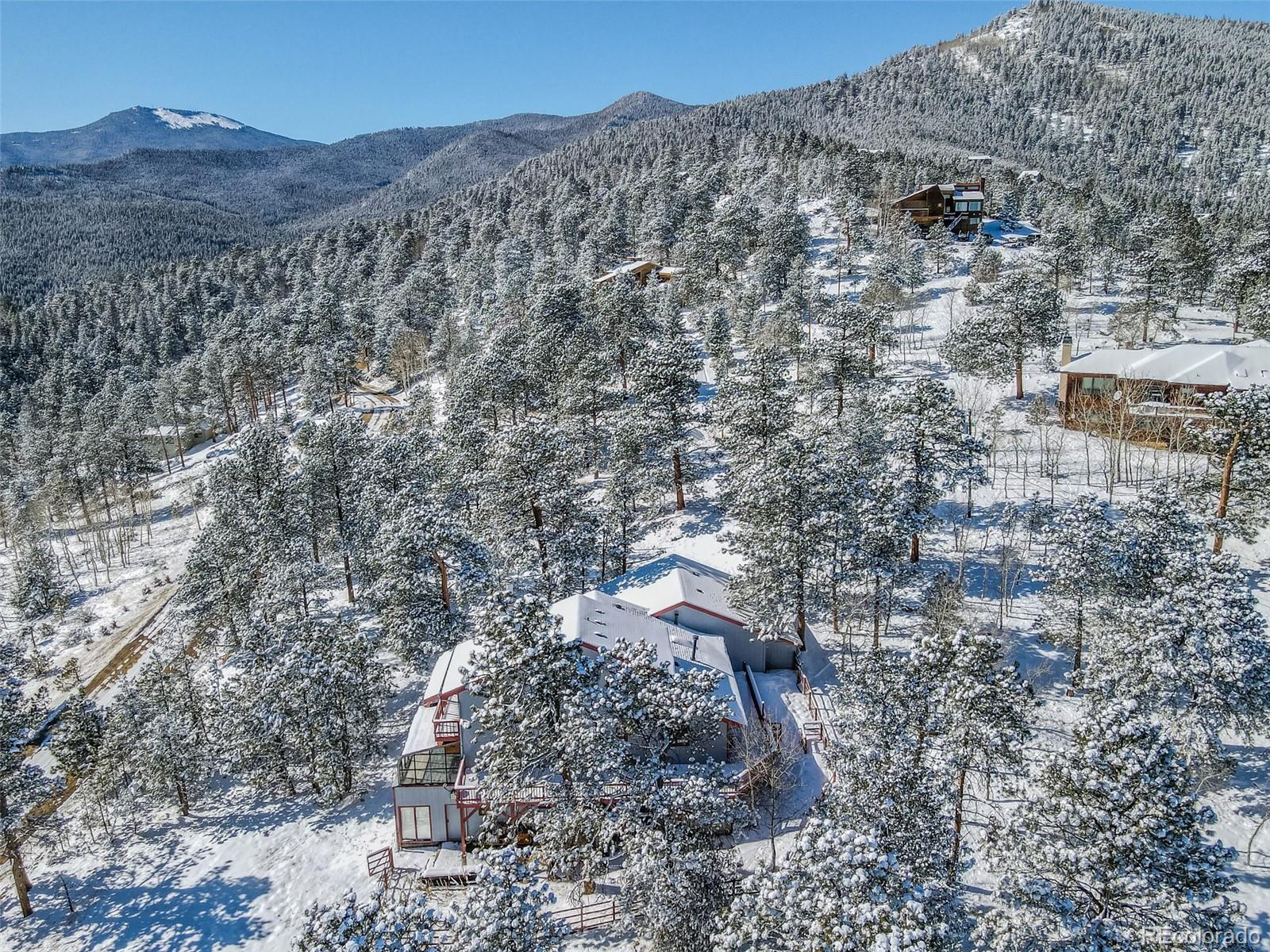 1189 Aspen Drive Evergreen, CO 80439 - Photo 33 of 37 a view of a dry field with trees in the background