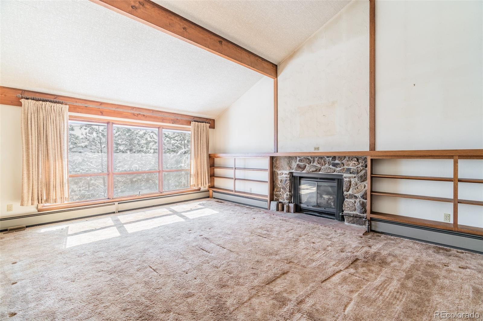 1189 Aspen Drive Evergreen, CO 80439 - Photo 10 of 37 an empty room with floor to ceiling window and an outdoor view