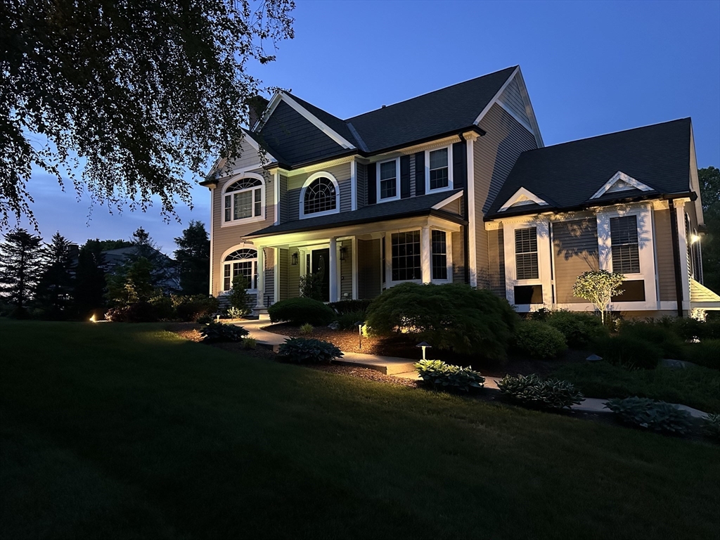 9 Round Farm Road Rehoboth, MA 02769 - Photo 4 of 41 a front view of a house with a yard and lake view