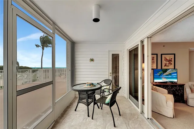 a view of a dining room with furniture and a window