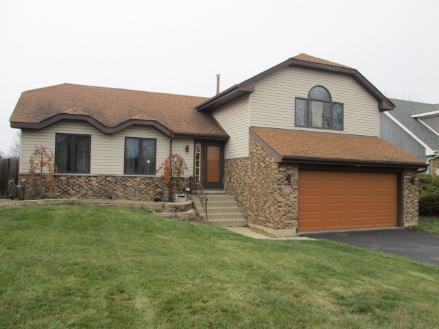 3456 Ronald Road Crete, IL 60417 - Photo 1 of 20 a front view of a house with a garden and yard