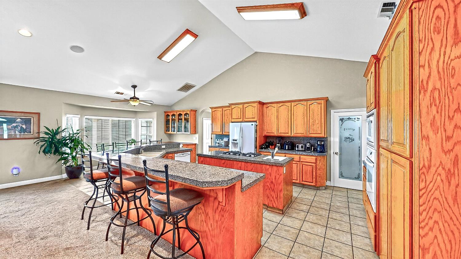 770 Merriam Road Hickman, CA 95323 - Photo 16 of 91 a dining hall with stainless steel appliances kitchen island granite countertop a table and chairs in it