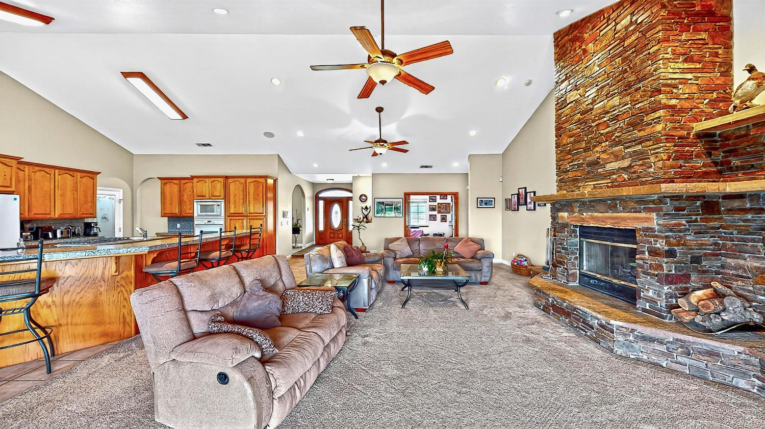 770 Merriam Road Hickman, CA 95323 - Photo 25 of 91 a living room with furniture a fireplace and a chandelier
