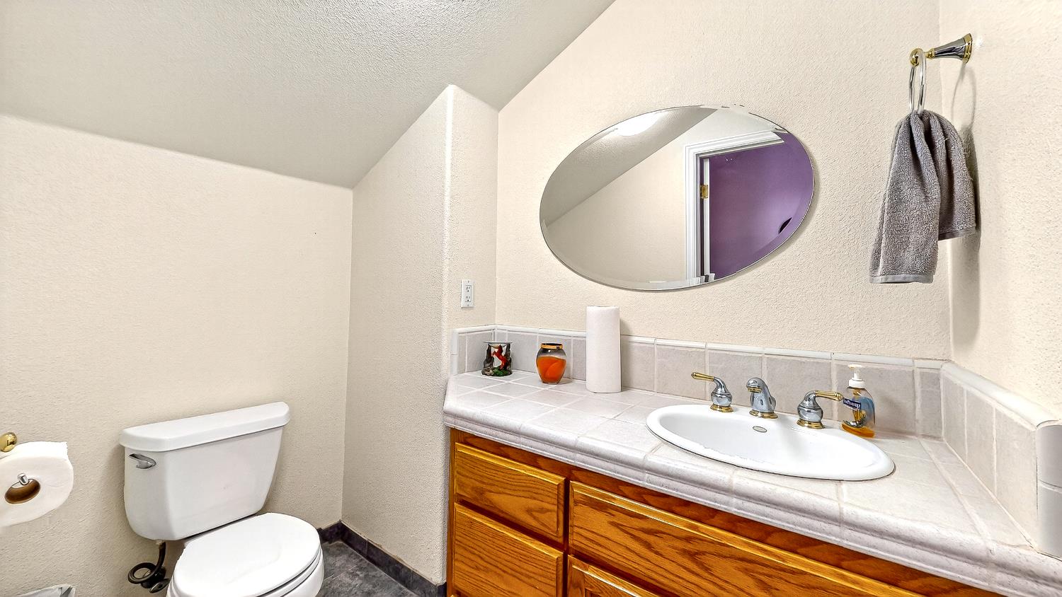 770 Merriam Road Hickman, CA 95323 - Photo 38 of 91 a bathroom with a granite countertop sink and a mirror