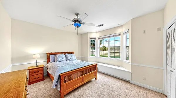 a view of a livingroom with a ceiling fan and window