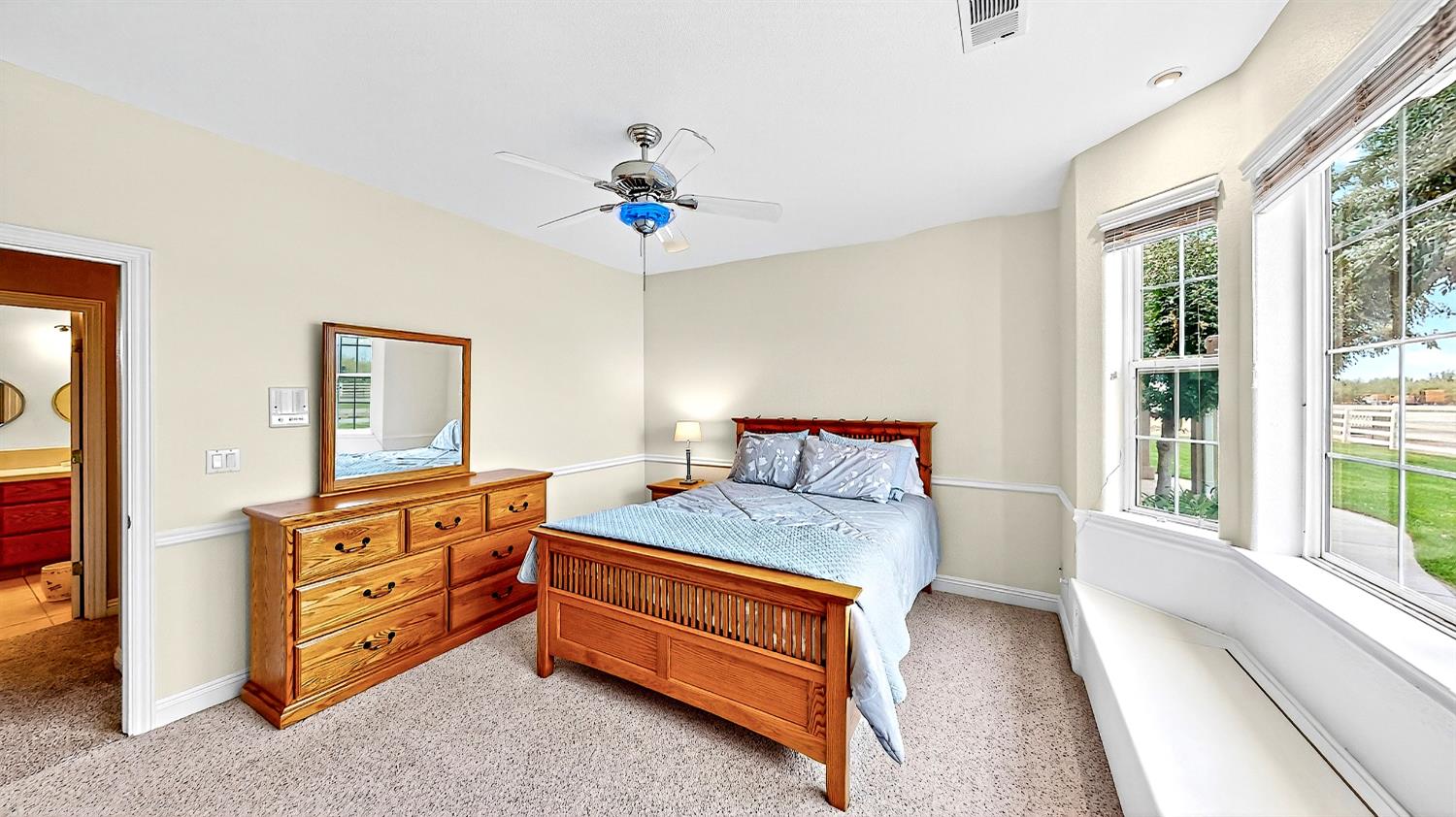 770 Merriam Road Hickman, CA 95323 - Photo 43 of 91 a bedroom with a bed and a chandelier