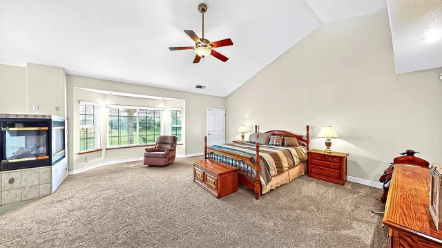 an aerial view of a house with a garden and lake view