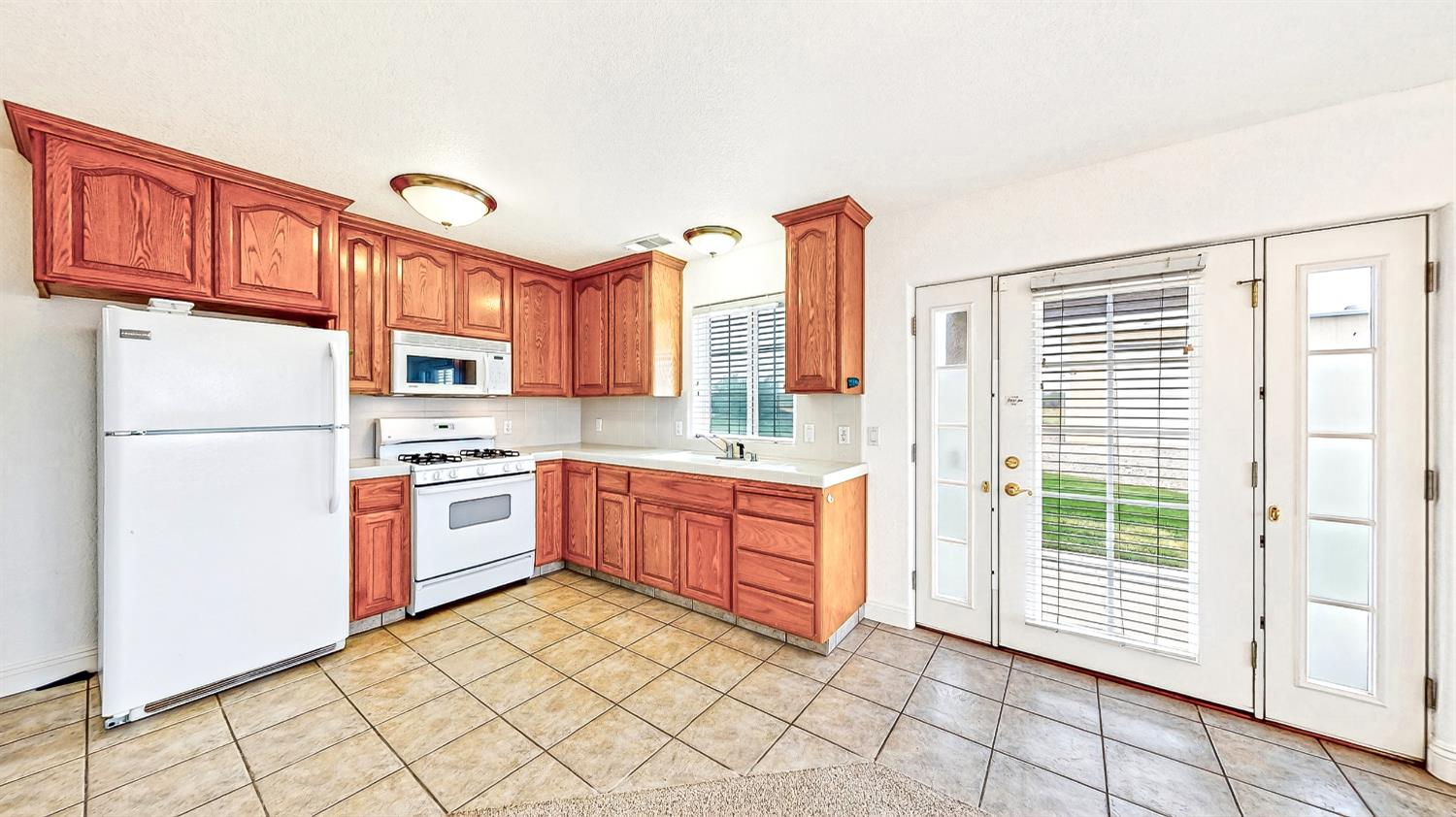770 Merriam Road Hickman, CA 95323 - Photo 60 of 91 a kitchen with stainless steel appliances granite countertop a refrigerator sink and cabinets
