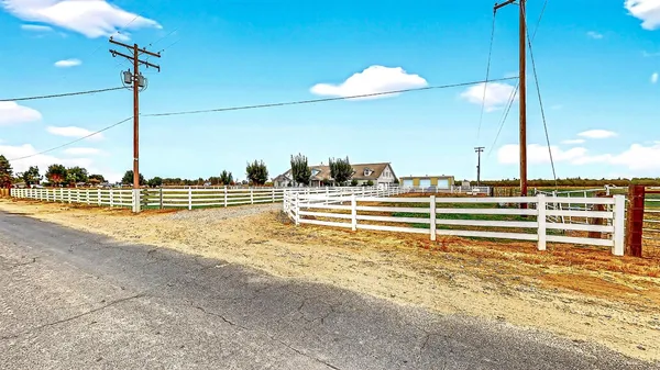 a living room with furniture a chandelier and a rug