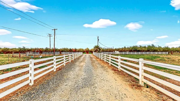 a living room with patio furniture and a large window