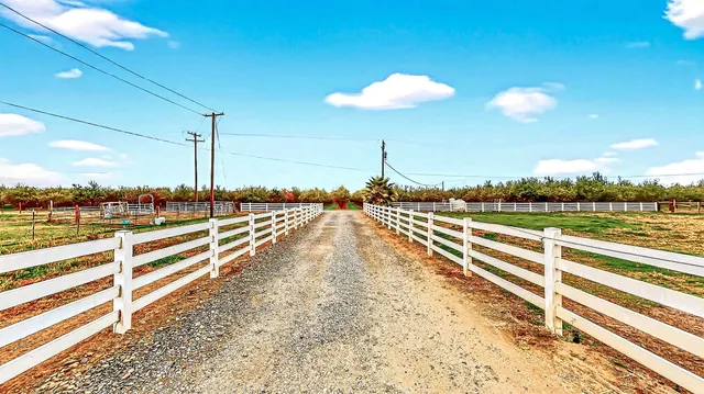 a living room with patio furniture and a large window