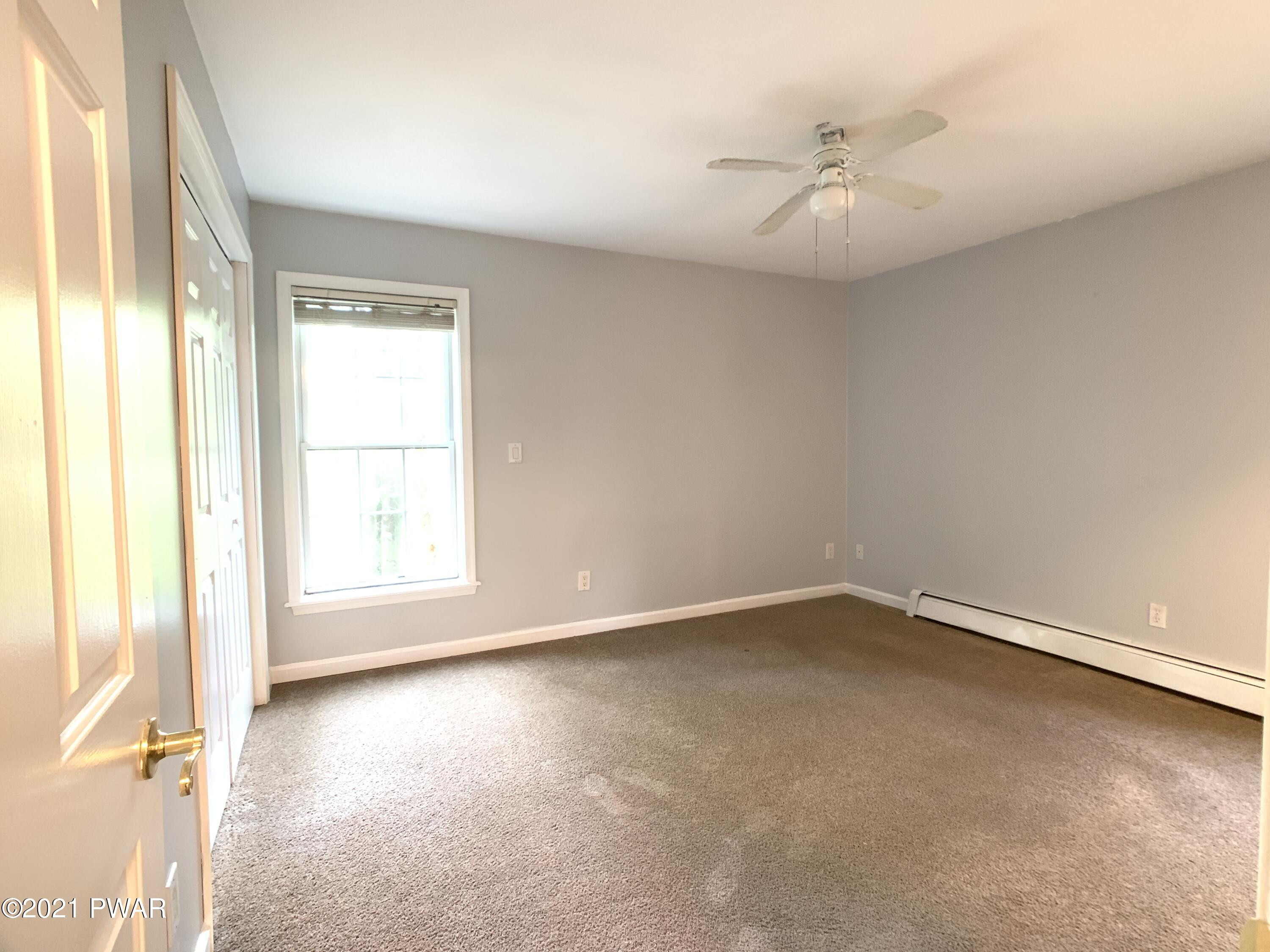 267 North Northgate Road Lake Ariel, PA 18436 - Photo 10 of 29 an empty room with a window and a ceiling fan