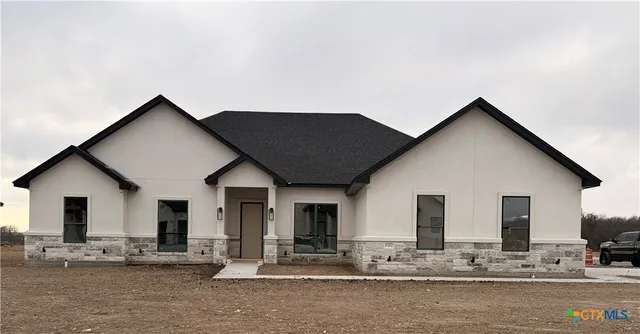 a view of a white house with large windows