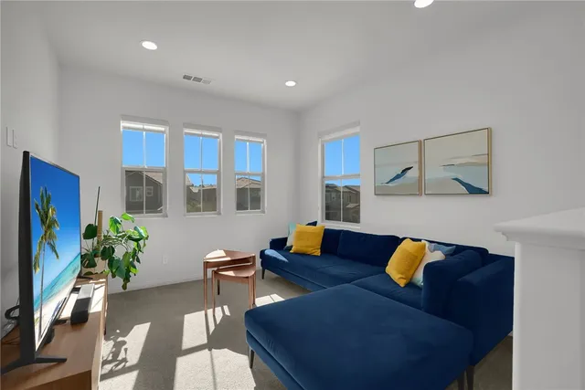 a living room with furniture and flowers