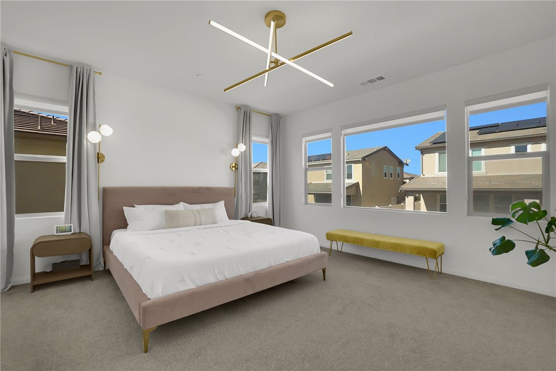 32136 Dymondia Way Temecula, CA 92591 - Photo 20 of 40 a bedroom with a bed and a chandelier