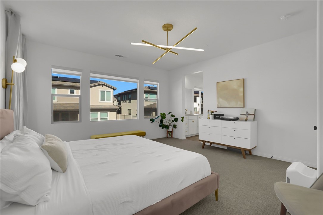 32136 Dymondia Way Temecula, CA 92591 - Photo 21 of 40 a bedroom with a large bed and a chandelier