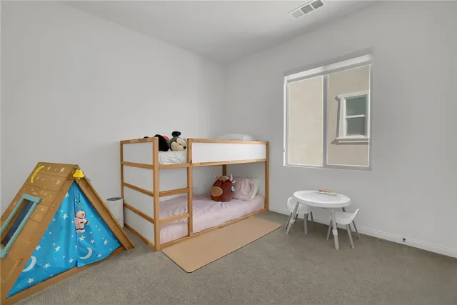 a bedroom with a bunk bed and a dresser