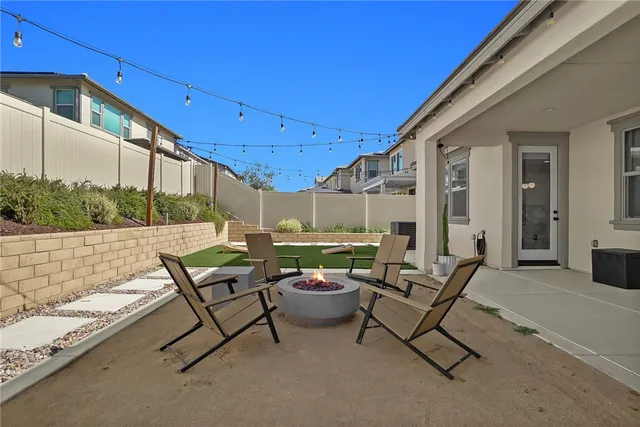 a building outdoor space with patio furniture and potted plants