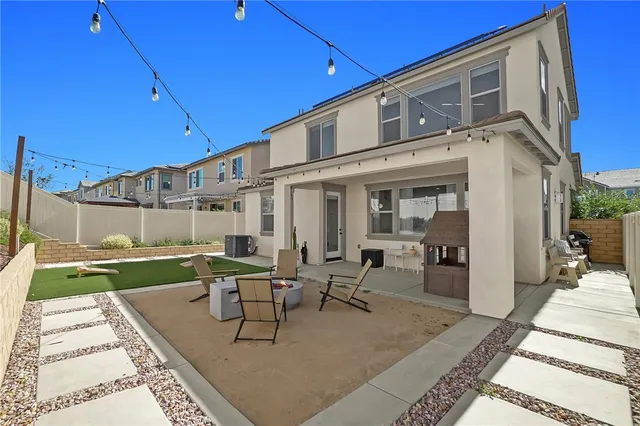 a view of a patio with table and chairs with wooden floor and fence