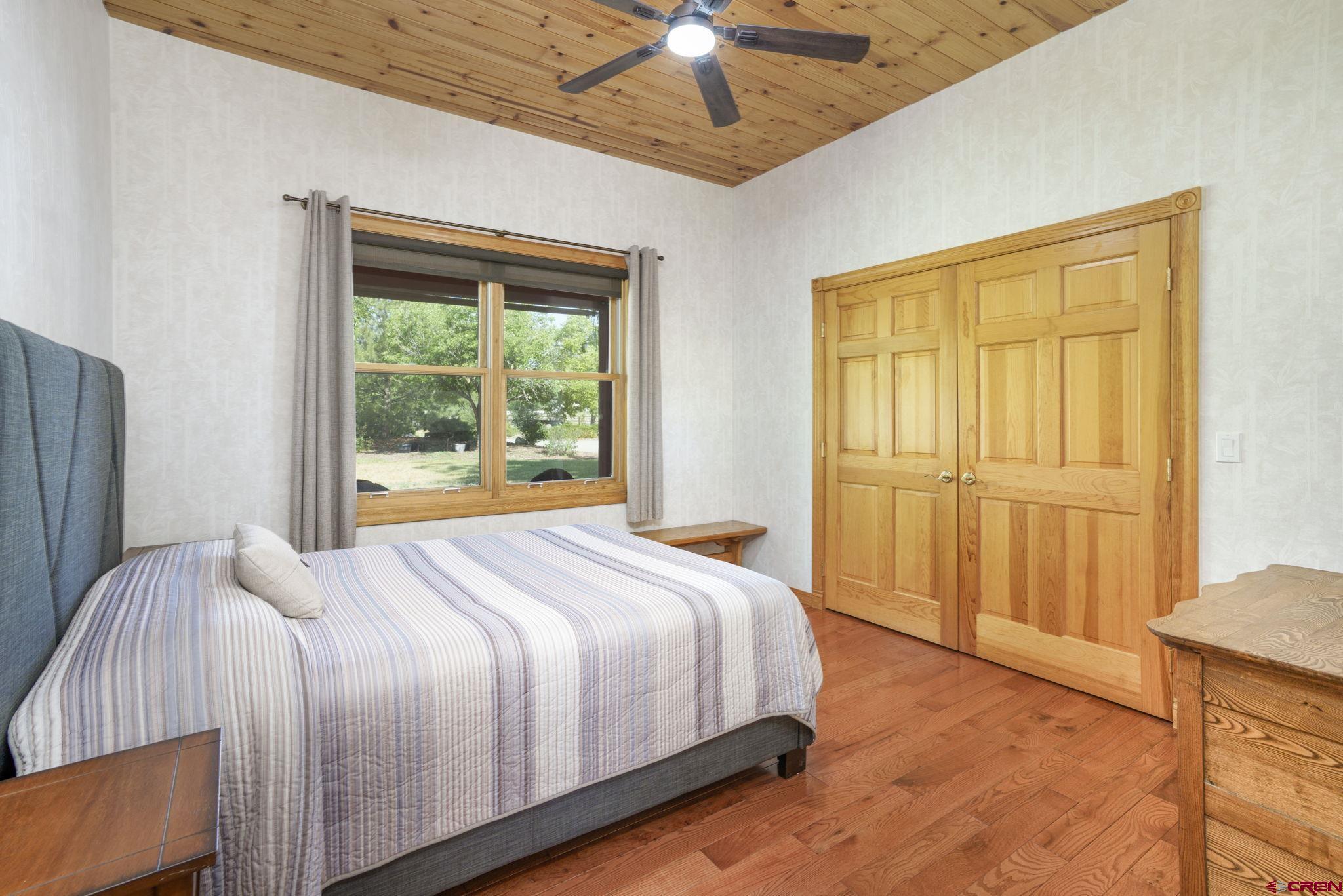 9113 Coogans Bluff Road Austin, CO 81410 - Photo 11 of 22 a bed sitting in a spacious bedroom next to a window