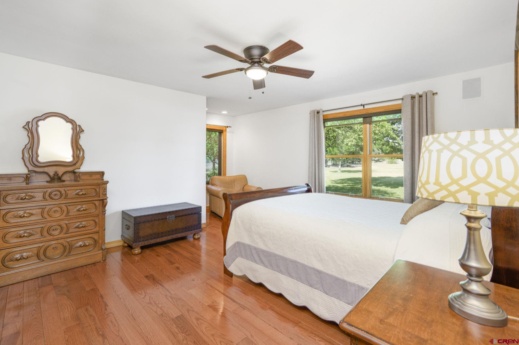 9113 Coogans Bluff Road Austin, CO 81410 - Photo 12 of 22 a bedroom with a bed and dresser with mirror