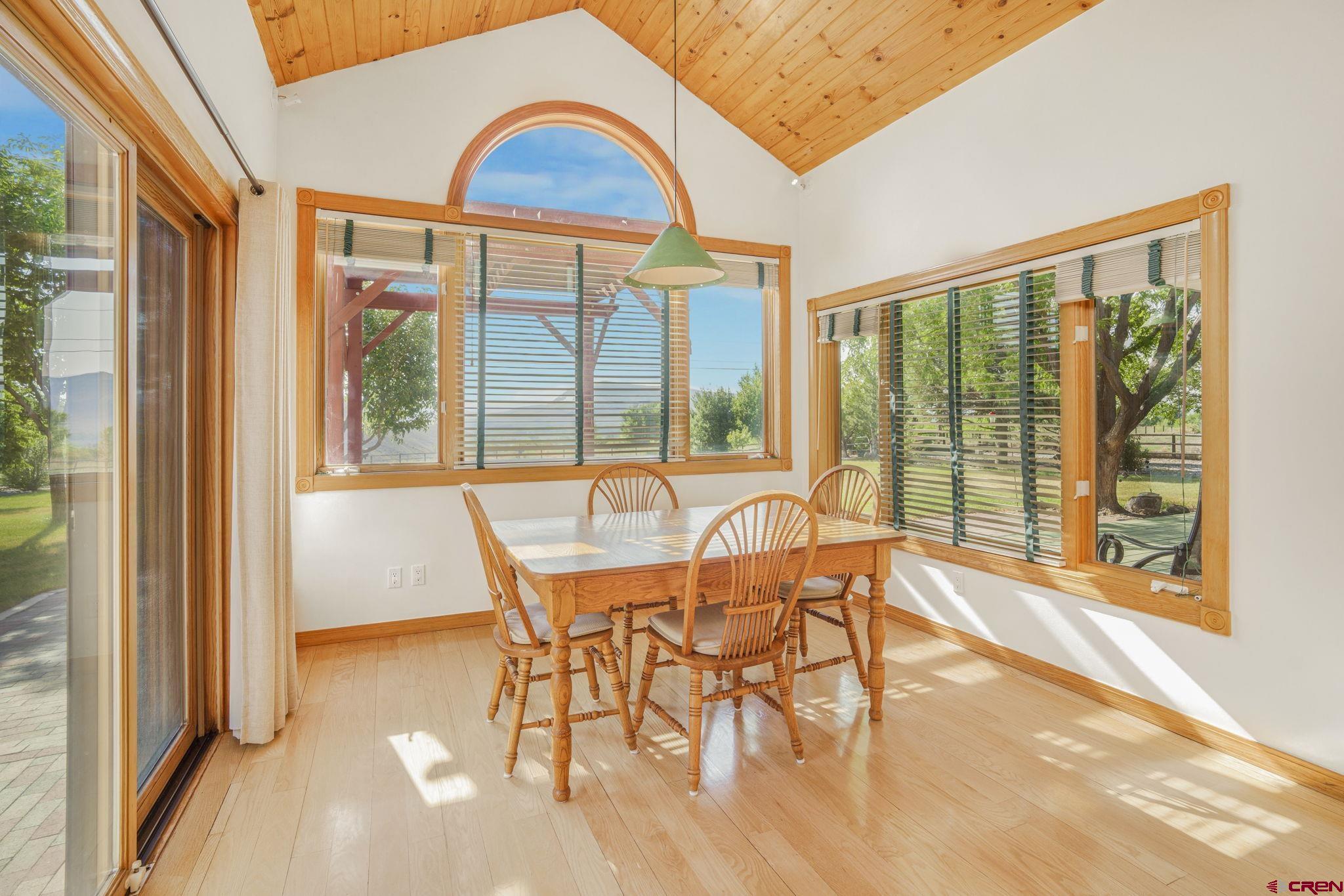 9113 Coogans Bluff Road Austin, CO 81410 - Photo 4 of 22 a view of a dining room with furniture large windows and wooden floor