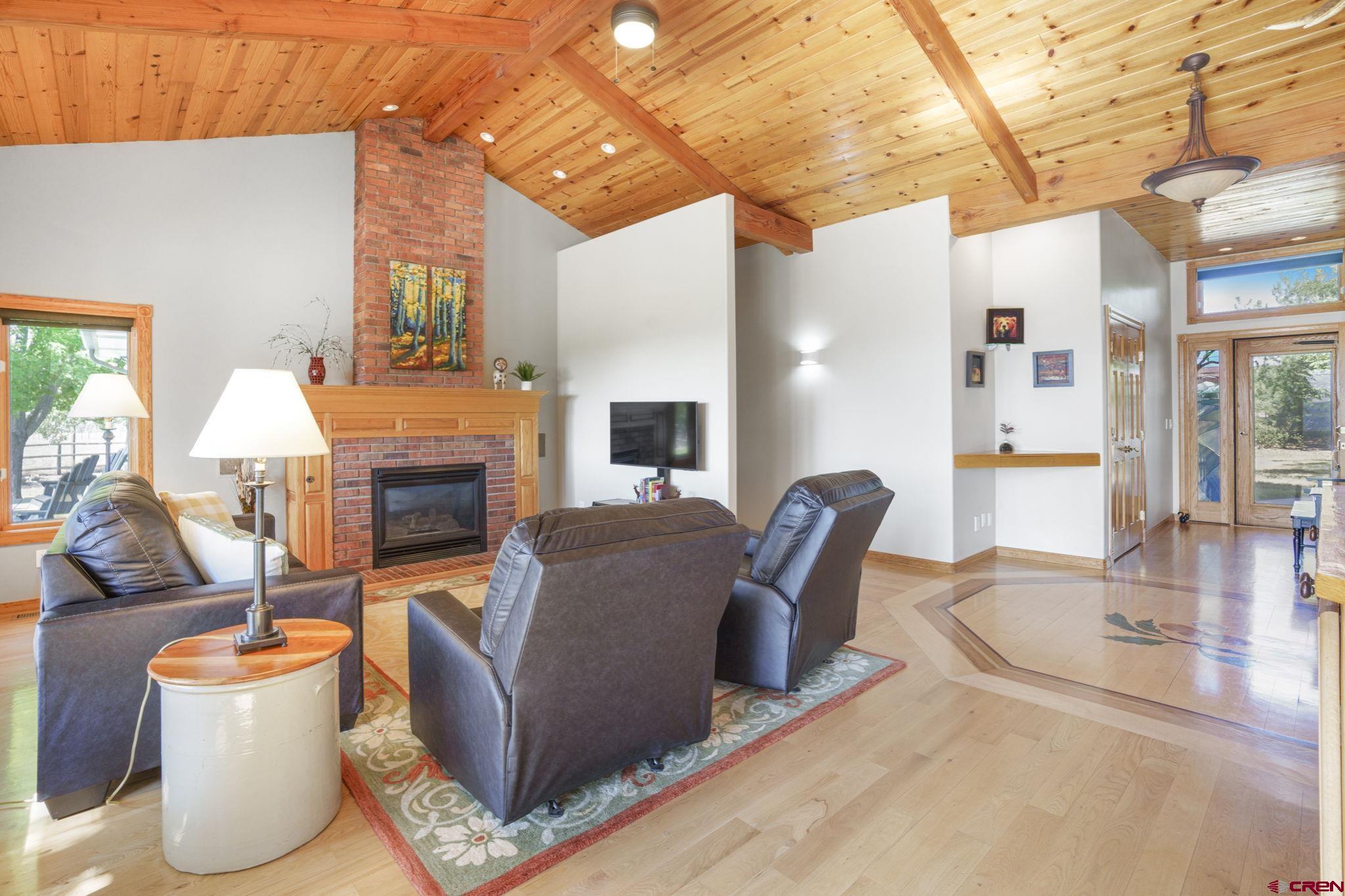 9113 Coogans Bluff Road Austin, CO 81410 - Photo 5 of 22 a living room with furniture a fireplace and a table