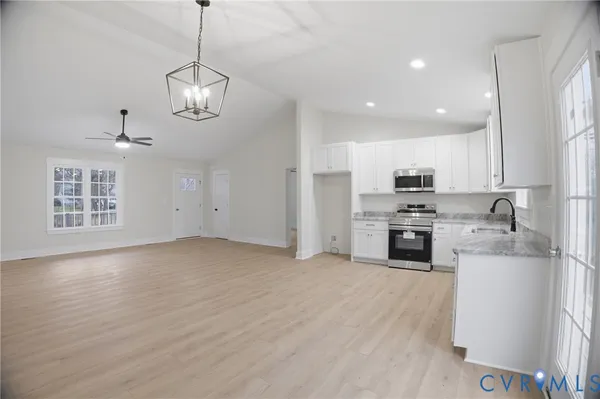 a kitchen with stainless steel appliances a refrigerator sink and microwave