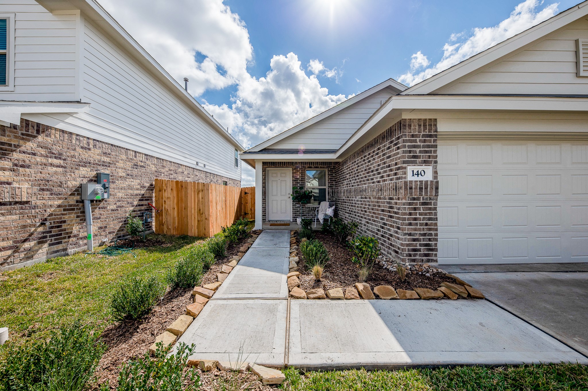 140 Austin Street Angleton, TX 77515 - Photo 2 of 27 Paved walkway from your two car garage with remove control access and double wide driveway.