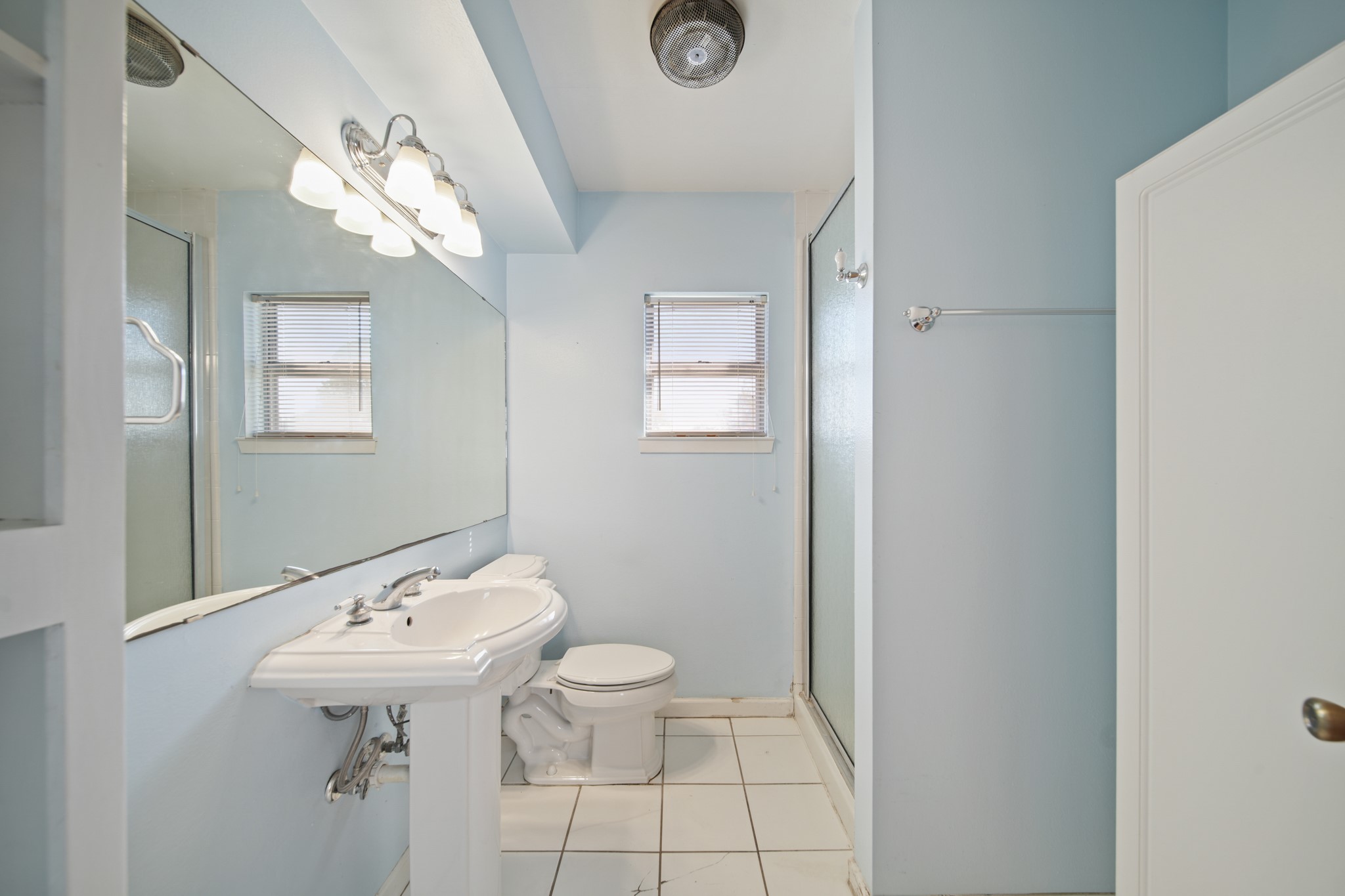 1811 Mulcahy Street Rosenberg, TX 77471 - Photo 14 of 25 a bathroom with a sink a toilet and mirror