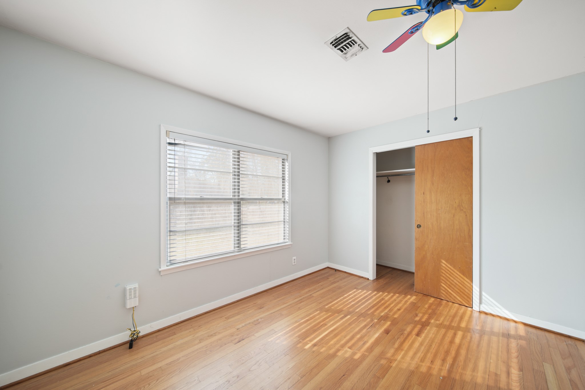 1811 Mulcahy Street Rosenberg, TX 77471 - Photo 16 of 25 a view of empty room with wooden floor and fan