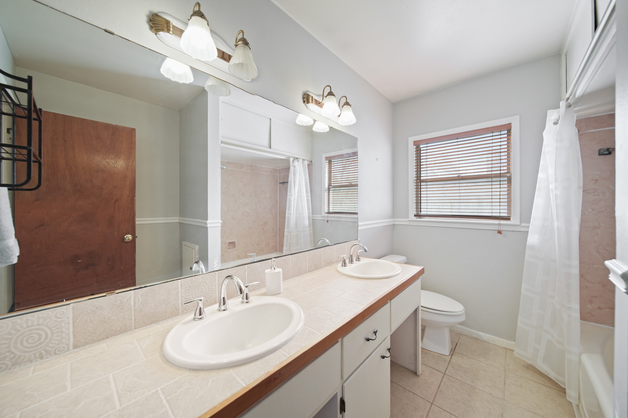 1811 Mulcahy Street Rosenberg, TX 77471 - Photo 18 of 25 a bathroom with a granite countertop sink a toilet and a mirror