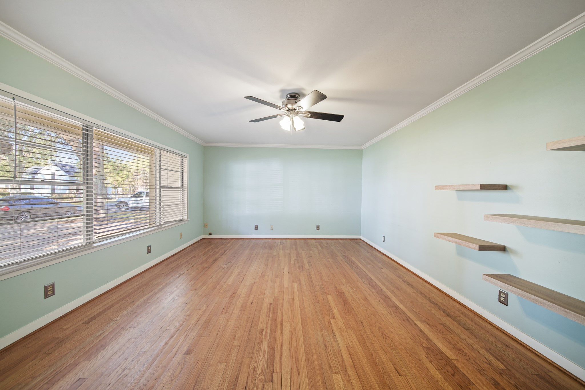 1811 Mulcahy Street Rosenberg, TX 77471 - Photo 4 of 25 a view of an empty room with a window and wooden floor
