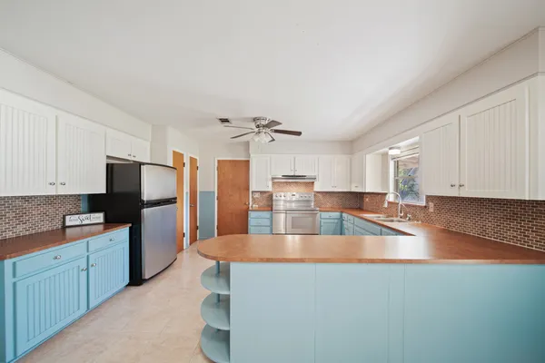 a kitchen with stainless steel appliances granite countertop a sink refrigerator and microwave
