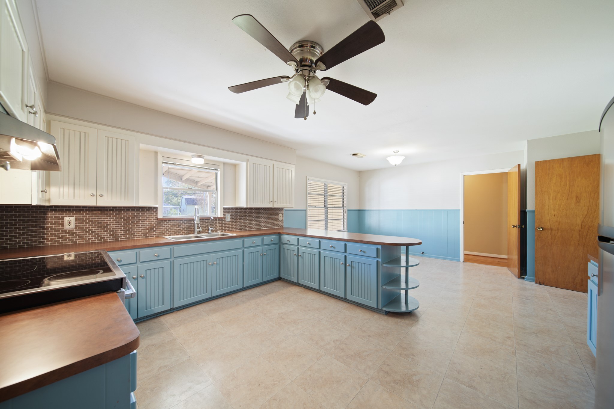 1811 Mulcahy Street Rosenberg, TX 77471 - Photo 9 of 25 a kitchen with stainless steel appliances kitchen island hardwood floor sink and stove