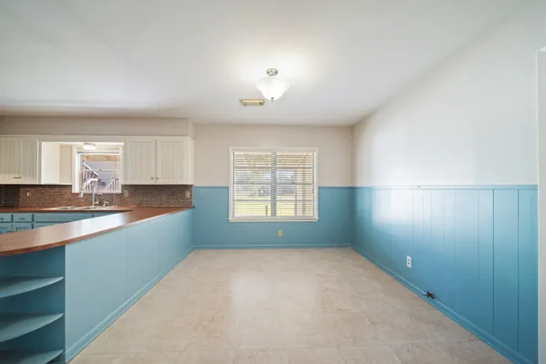 a big room with windows and cabinet