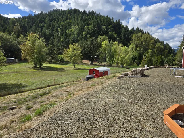 a view of a backyard with sitting area