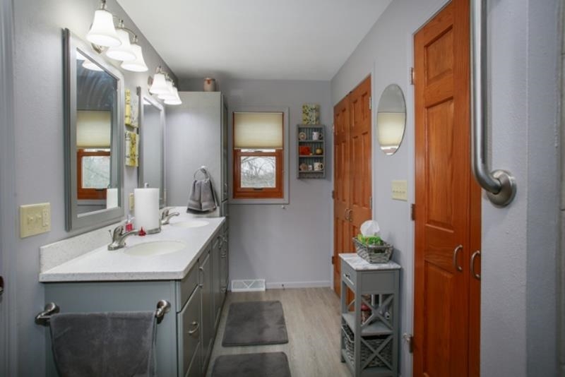 6727 North 5 Corners Road Lena, IL 61048 - Photo 11 of 20 a bathroom with a sink a mirror and a shower