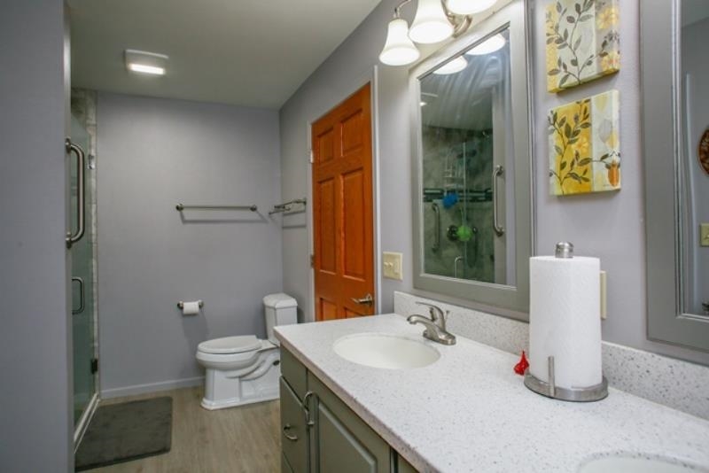 6727 North 5 Corners Road Lena, IL 61048 - Photo 12 of 20 a bathroom with a toilet sink and mirror
