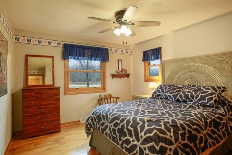 6727 North 5 Corners Road Lena, IL 61048 - Photo 13 of 20 a bedroom with a bed and a window