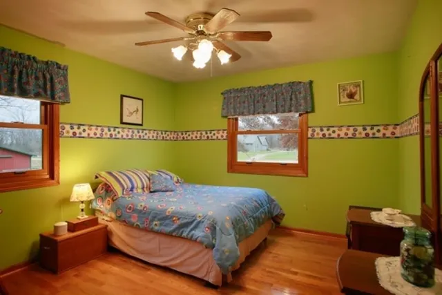 a bedroom with a bed furniture and wall painting