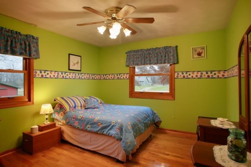 6727 North 5 Corners Road Lena, IL 61048 - Photo 14 of 20 a bedroom with a bed furniture and wall painting