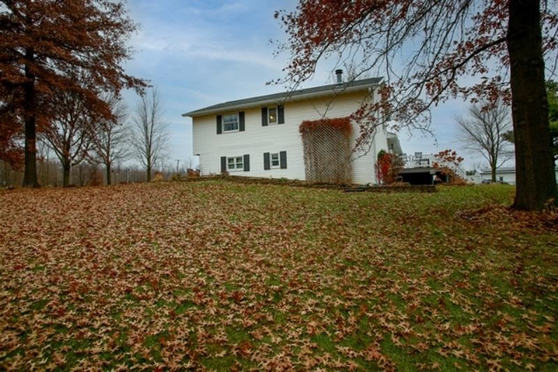 6727 North 5 Corners Road Lena, IL 61048 - Photo 17 of 20 a view of a house with a yard
