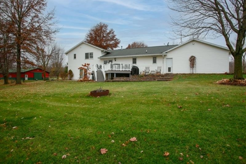 6727 North 5 Corners Road Lena, IL 61048 - Photo 18 of 20 a view of a house with a backyard