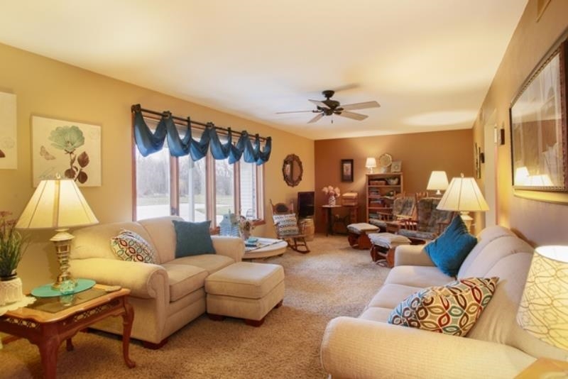 6727 North 5 Corners Road Lena, IL 61048 - Photo 2 of 20 a living room with furniture and a large window