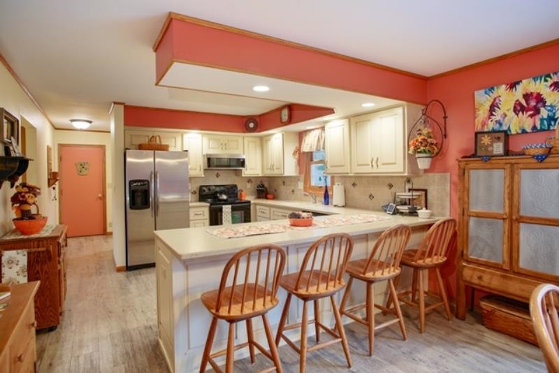 6727 North 5 Corners Road Lena, IL 61048 - Photo 3 of 20 a large kitchen with a table and chairs