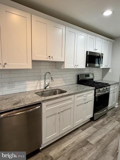 802 Devon Road Riverside, NJ 08075 - Photo 26 of 29 a kitchen with stainless steel appliances granite countertop a sink a stove a microwave and cabinets